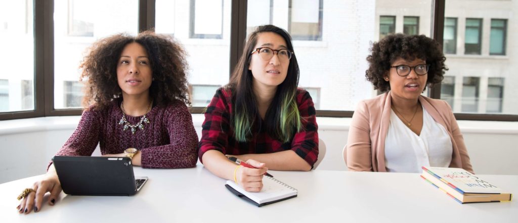 3 female tech workers at a desk